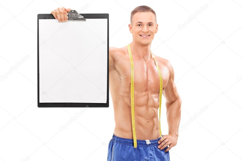 Shirtless male athlete holding clipboard