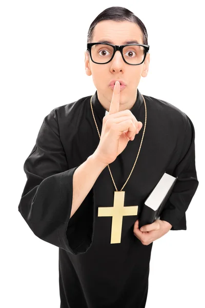 Sacerdote masculino segurando o dedo nos lábios — Fotografia de Stock