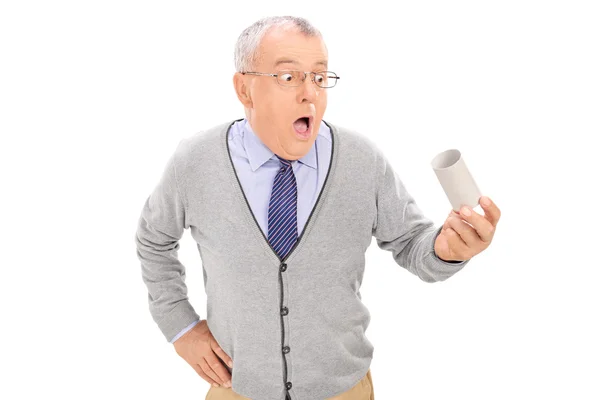 Senior holding empty toilet paper roll — Stock Photo, Image