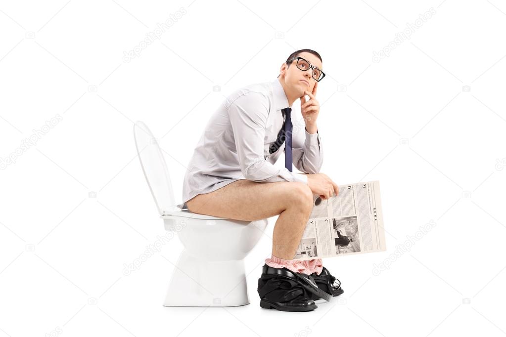 Man on toilet holding newspaper
