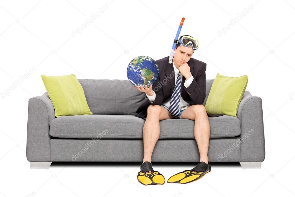 Sad businessman holding the earth
