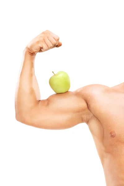 Brazo muscular con manzana en el bíceps —  Fotos de Stock