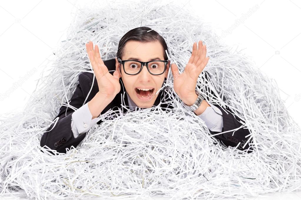 Man covered in pile of shredder paper
