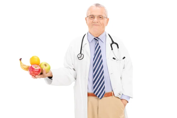 Doctor holding bunch of fruits — Stock Photo, Image