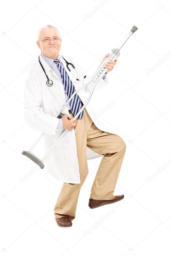 Mature doctor playing guitar on crutch