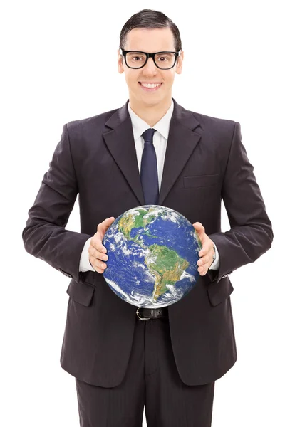 Young businessman holding the world — Stock Photo, Image