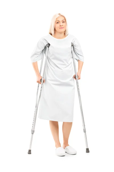 Female patient posing with crutches — Stock Photo, Image