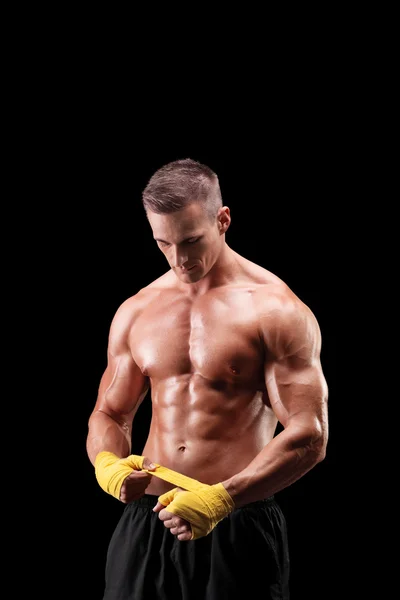 Handsome boxer bandaging his hands — Stock Photo, Image