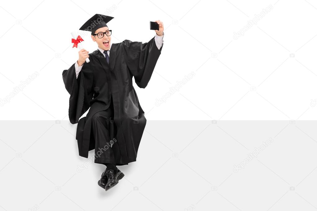 College graduate taking selfie