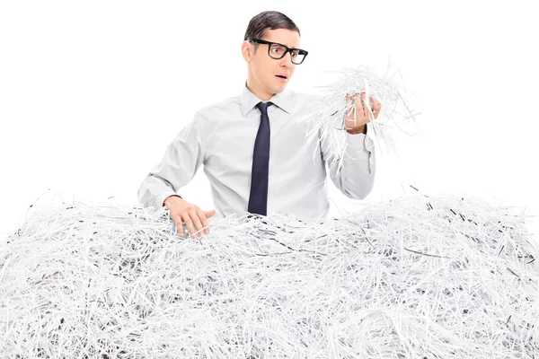 Worried businessman in shredded paper — Stock Photo, Image