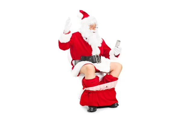 Papai Noel olhando papel higiênico — Fotografia de Stock