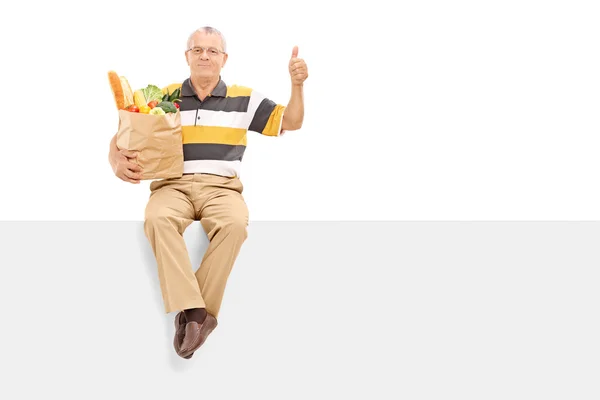 Senior with bag full of groceries — Stock Photo, Image