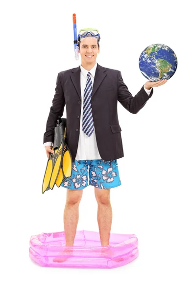 Businessman with diving mask holding earth — Stock Photo, Image