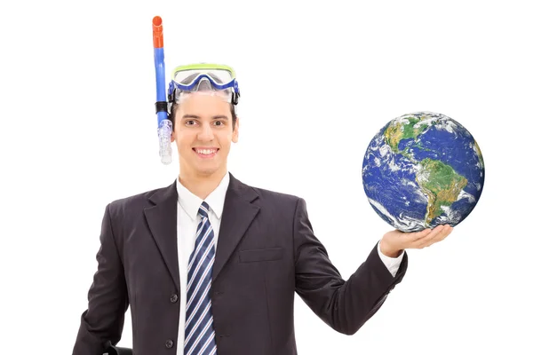 Businessman with diving mask holding earth — Stock Photo, Image