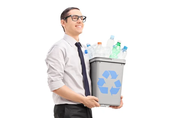 Young man carrying recycle bin — Stockfoto