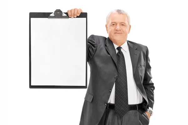 Mature businessman holding clipboard — Stock Photo, Image