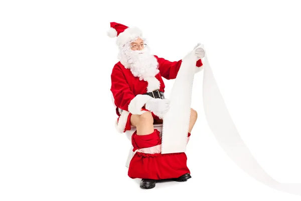 Santa sitter på toaletten — Stockfoto