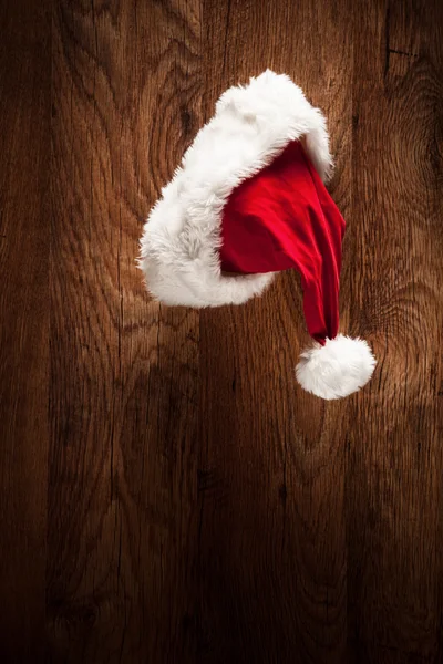 Santa hat on wooden surface — Stock Photo, Image