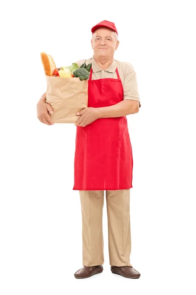 Vendor holding bag full of groceries — Stock Photo, Image