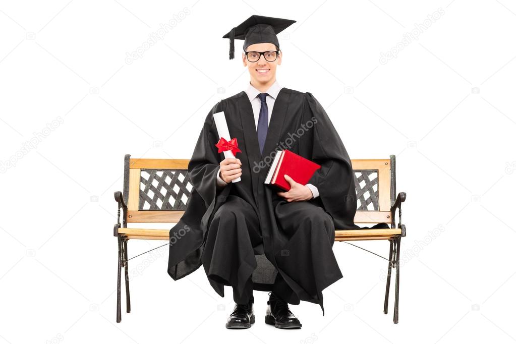 College graduate on bench holding diploma