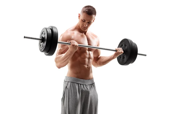 Handsome man lifting heavy barbell — Stock Photo, Image