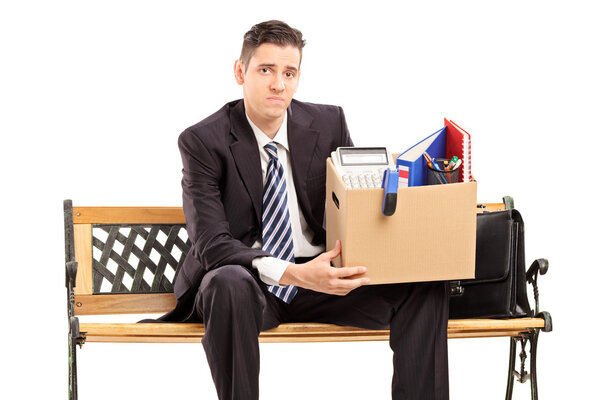 Fired businessman holding box with stuff