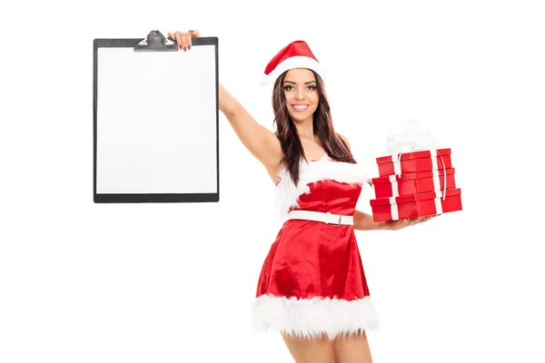 Girl in Santa costume holding gifts and clipboard — Stock Photo, Image