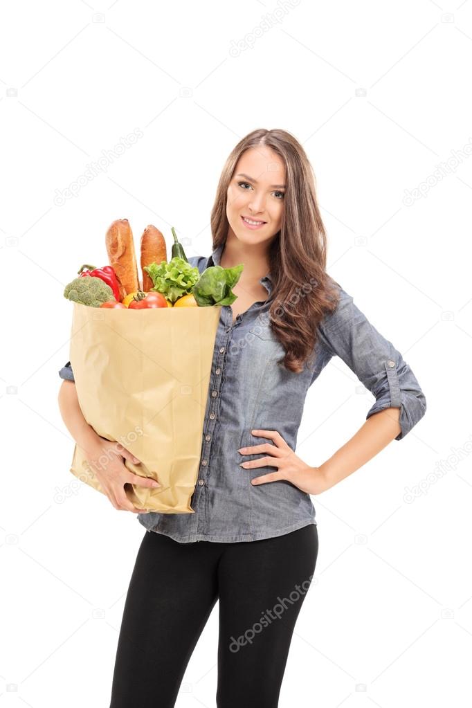 Girl carrying bag full of groceries