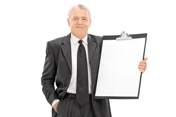 Mature businessman holding huge clipboard — Stock Photo, Image