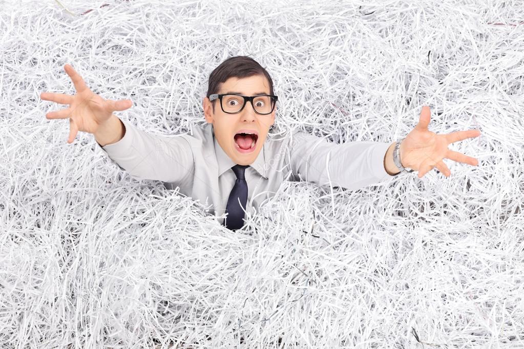 Man in pile of shredded paper