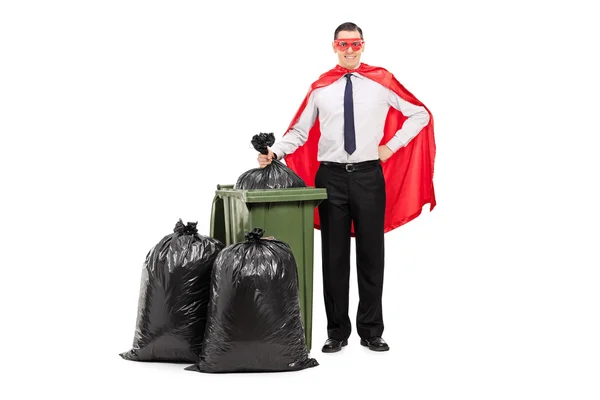 Superhero standing by trash can — Stock Photo, Image