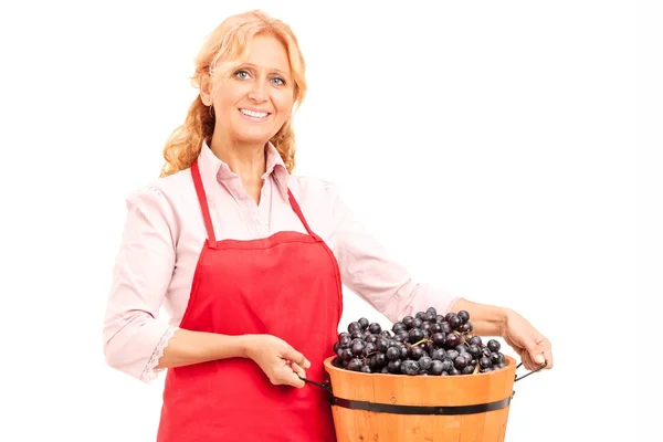 Lady holding a bucket of grapes — Stock Photo, Image