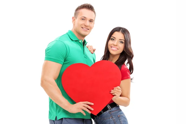 Casal segurando um coração vermelho — Fotografia de Stock