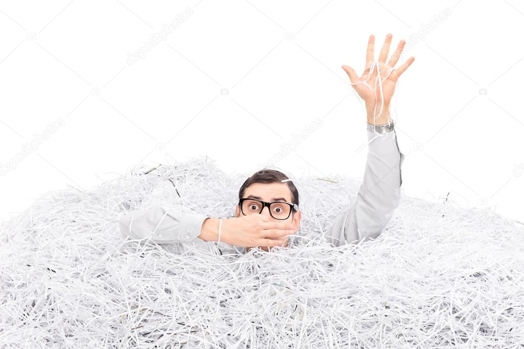 Man drowning in a pile paper