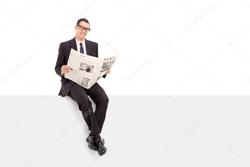 Businessman with newspaper on panel