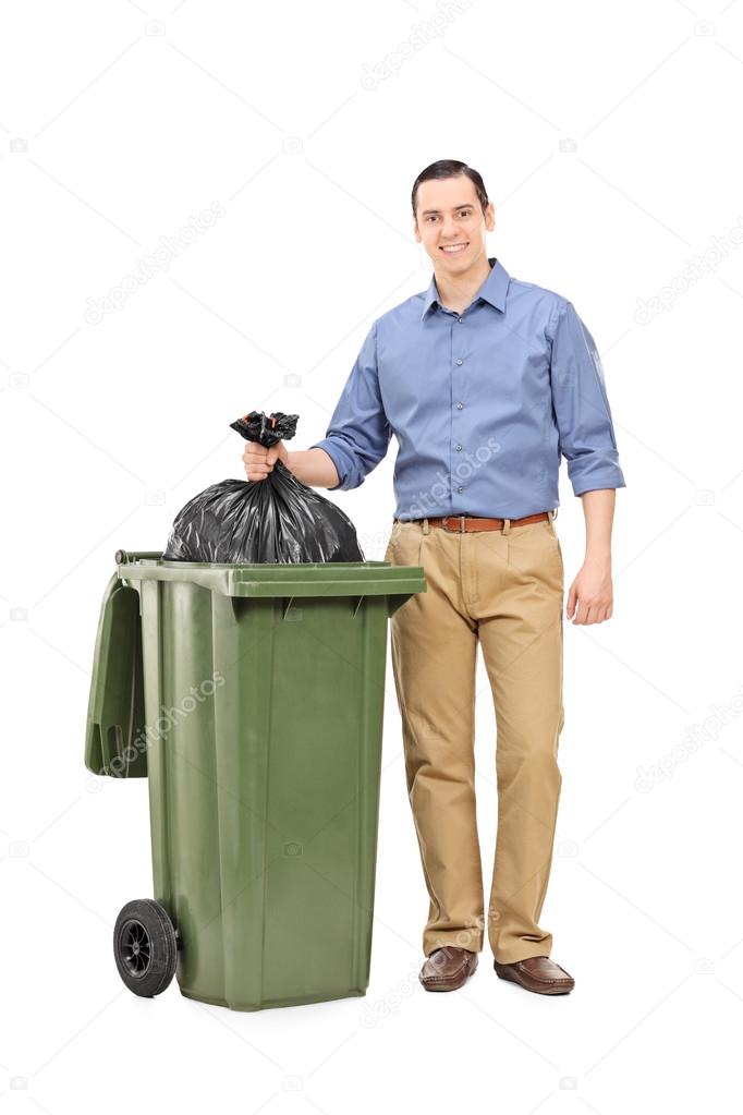 Young man throwing out garbage