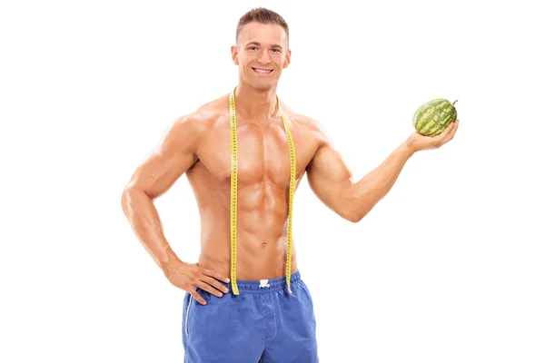 Shirtless man holding tiny watermelon — Stock Photo, Image