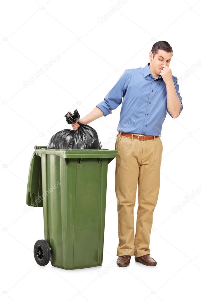 Man throwing out bag of trash