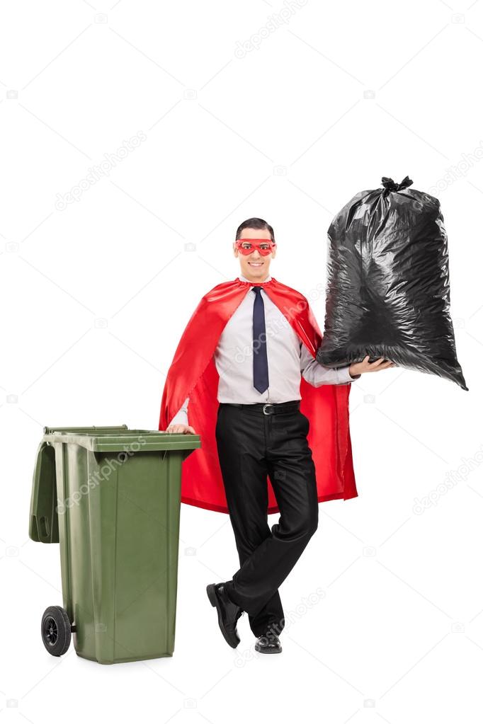 Superhero holding large trash bag