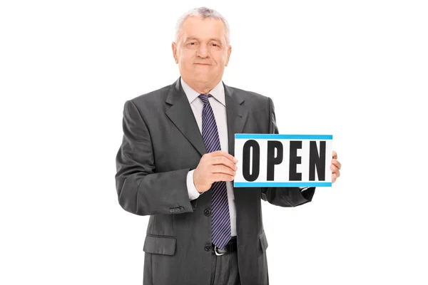 Mature businessman holding open sign — Stock Photo, Image