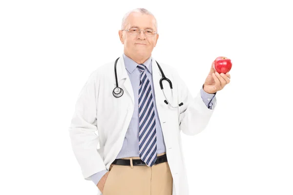 Ώριμη γιατρός εκμετάλλευση ώριμο μήλο — Φωτογραφία Αρχείου