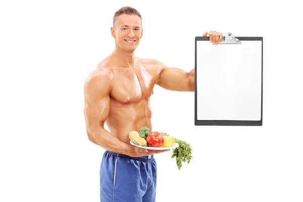 Athlete holding plate with vegetables — Stock Photo, Image