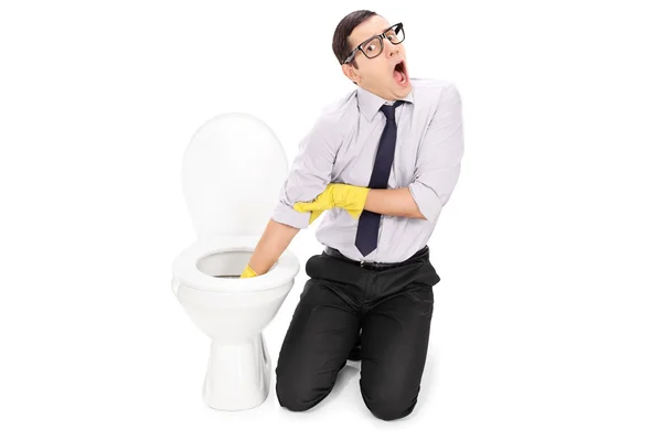 Man cleaning toilet with cleaning gloves — Stock Photo, Image