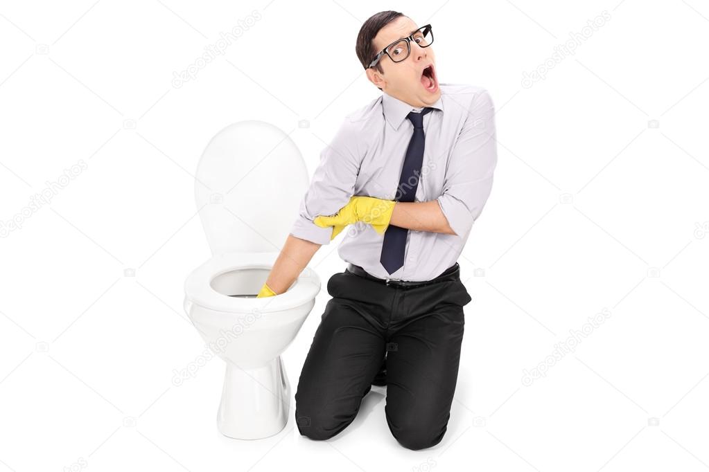Man cleaning toilet with cleaning gloves