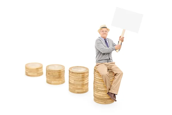 Senior on pile of coins — Stock Photo, Image