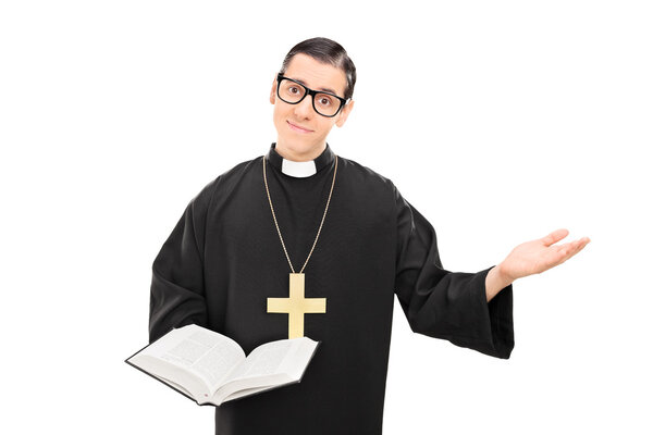 Young Catholic priest holding bible