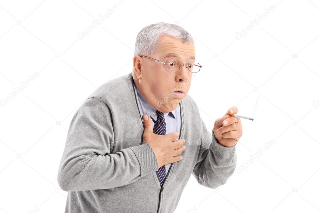 Senior man choking from smoke