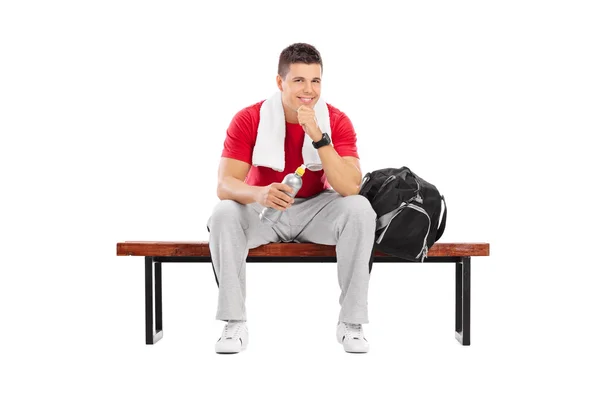 Handsome sportsman sitting on bench — Stock Photo, Image