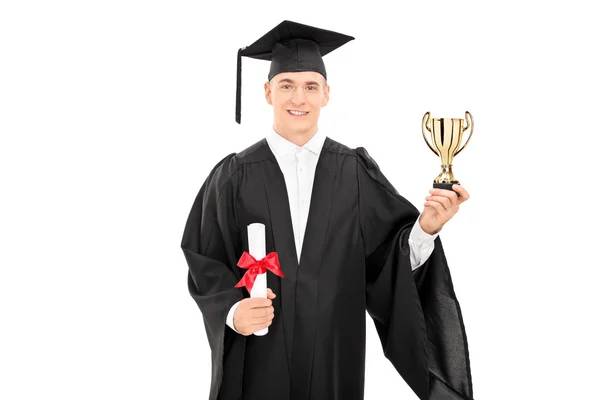 College graduate holding golden trophy — Stock Photo, Image