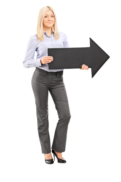 Full length portrait of a blond smiling woman holding an arrow — Stock Photo, Image